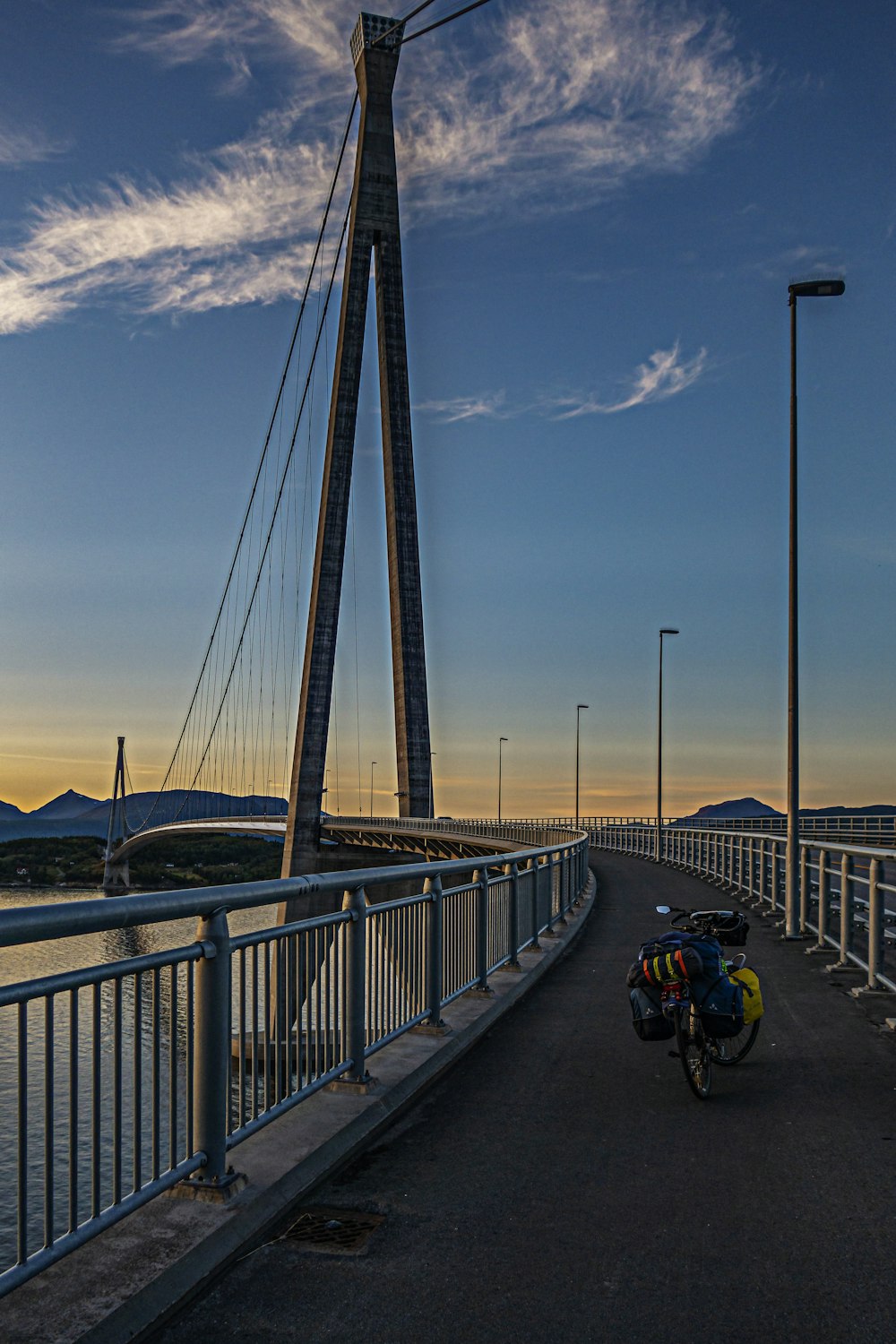 a bike parked on a bridge over a body of water