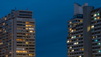 a couple of tall buildings sitting next to each other