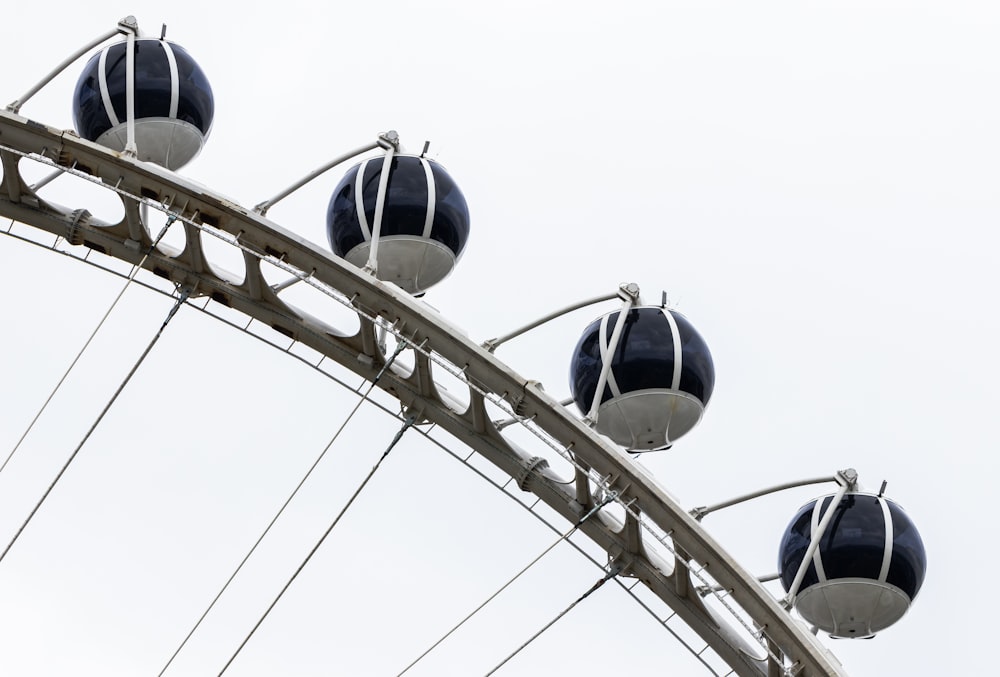 a close up of a ferris wheel with a sky background