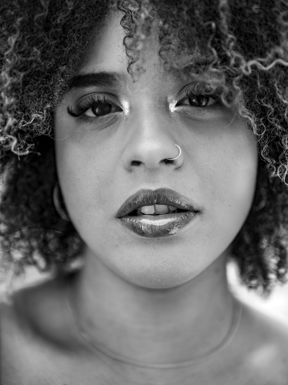 a black and white photo of a woman with curly hair