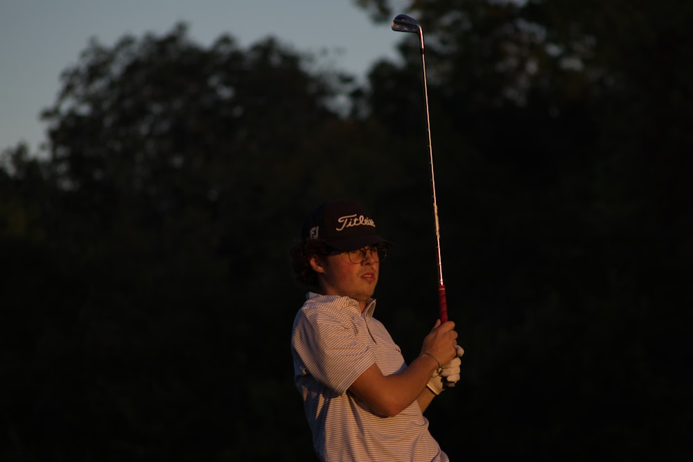 a man swinging a golf club at a ball