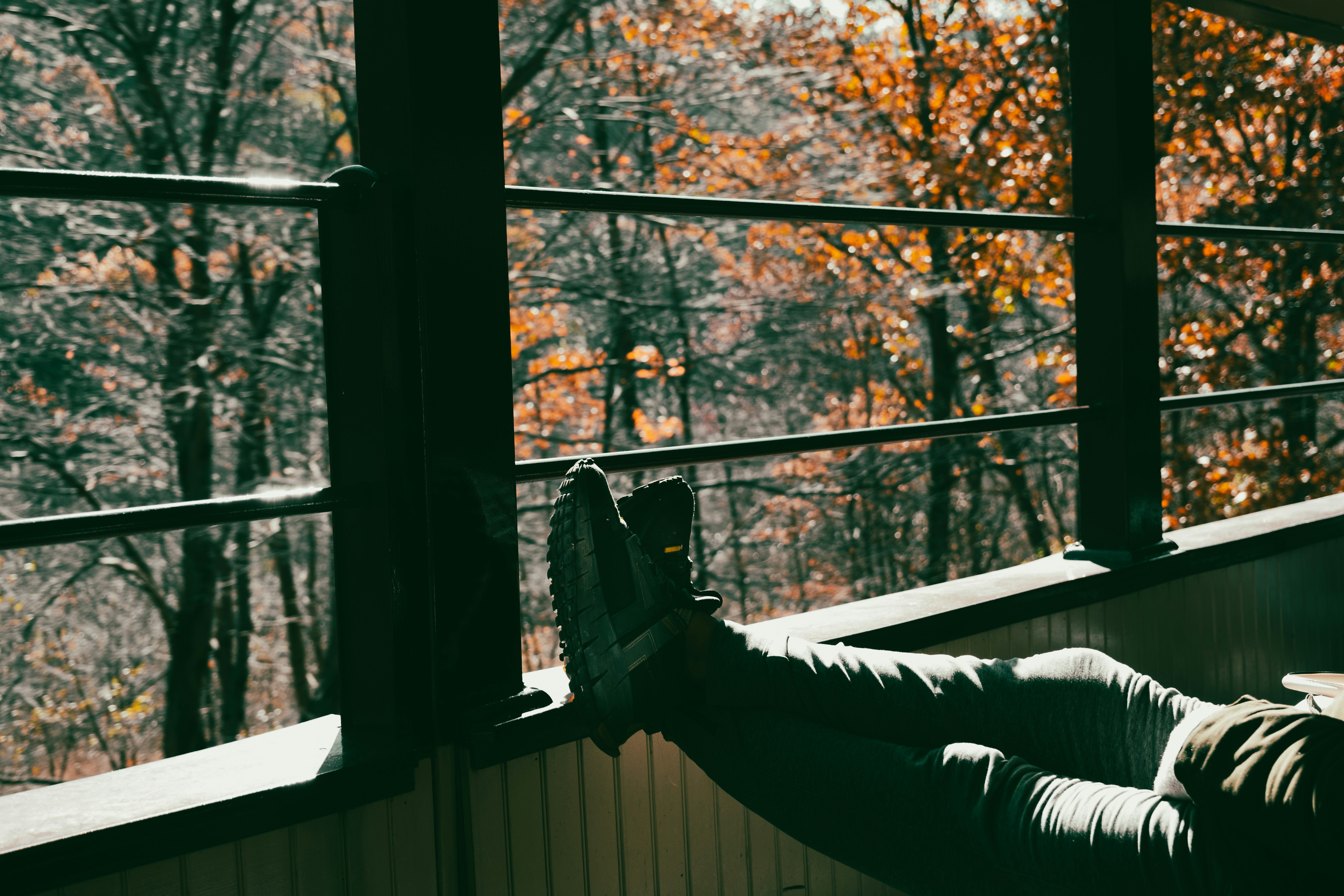 a person laying on a porch with their feet up, 