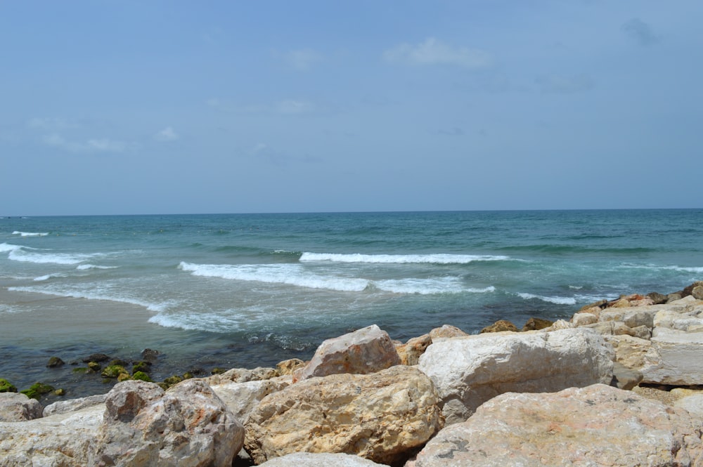 a view of the ocean from a rocky shore