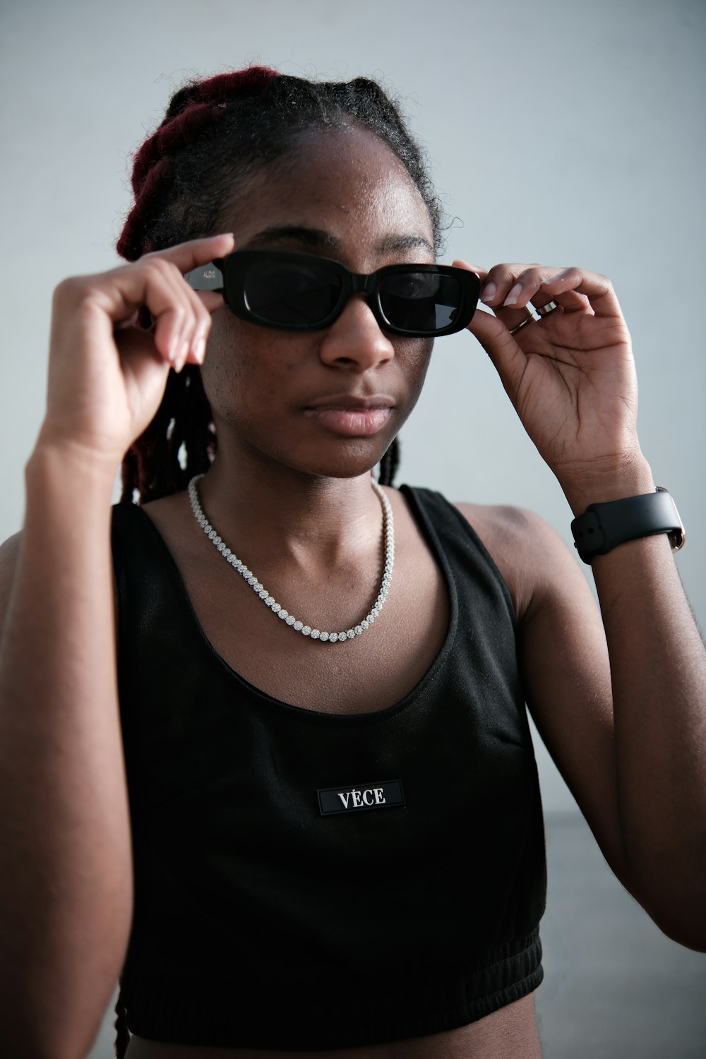 a woman wearing sunglasses and a black top