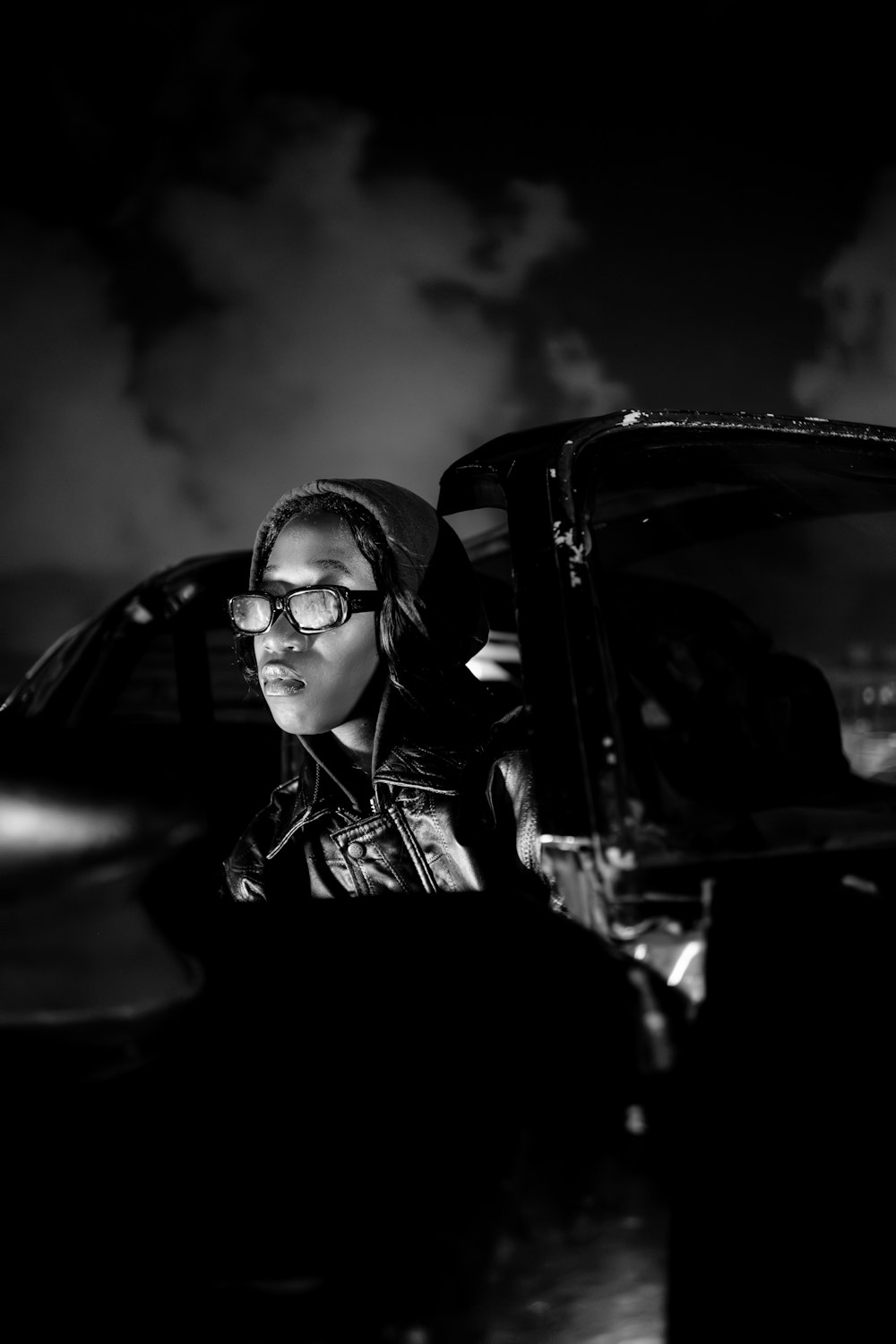 a woman with glasses sitting in front of a piano