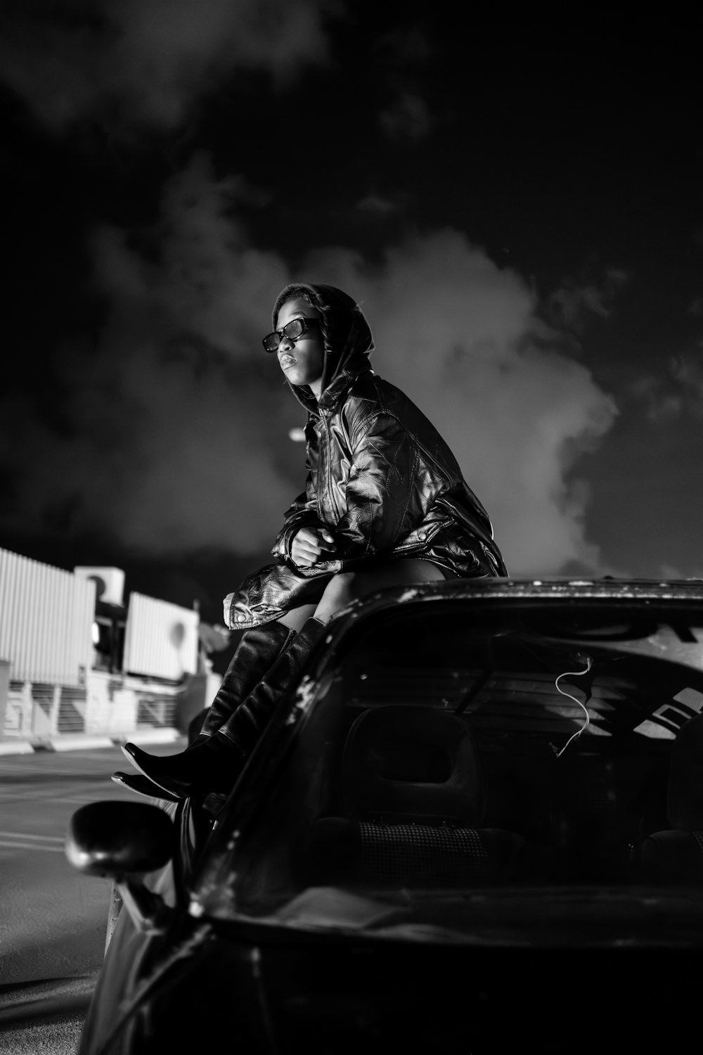 a man sitting on the hood of a car