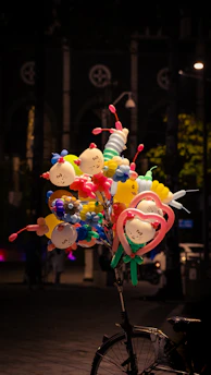a bicycle with a bunch of balloons attached to it
