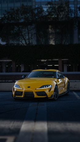 a yellow sports car parked in a parking lot