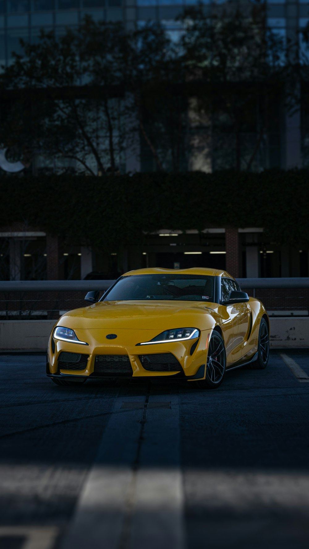 a yellow sports car parked in a parking lot