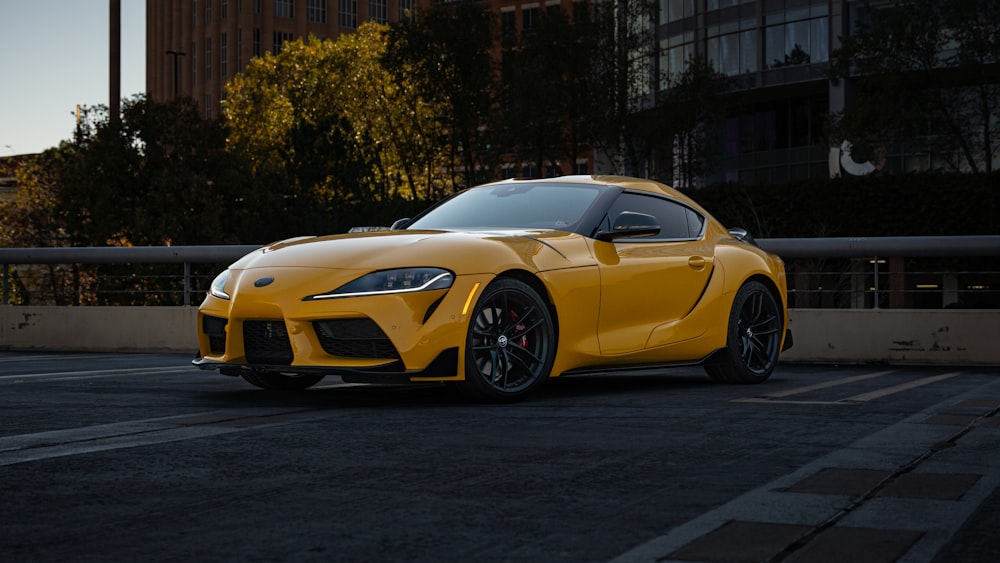 a yellow sports car parked in a parking lot