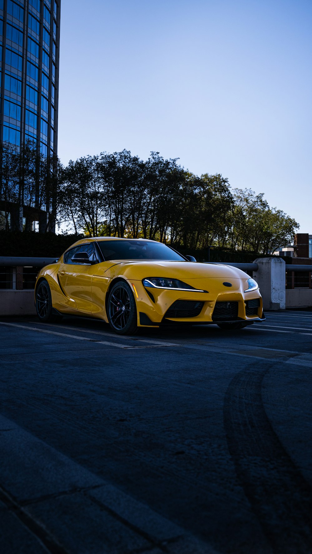 a yellow sports car parked in a parking lot