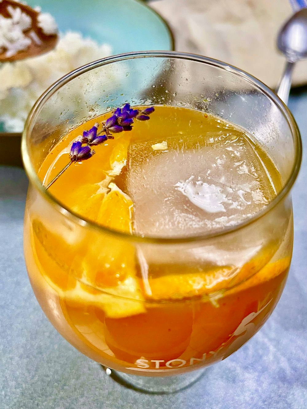 a glass filled with a drink sitting on top of a table