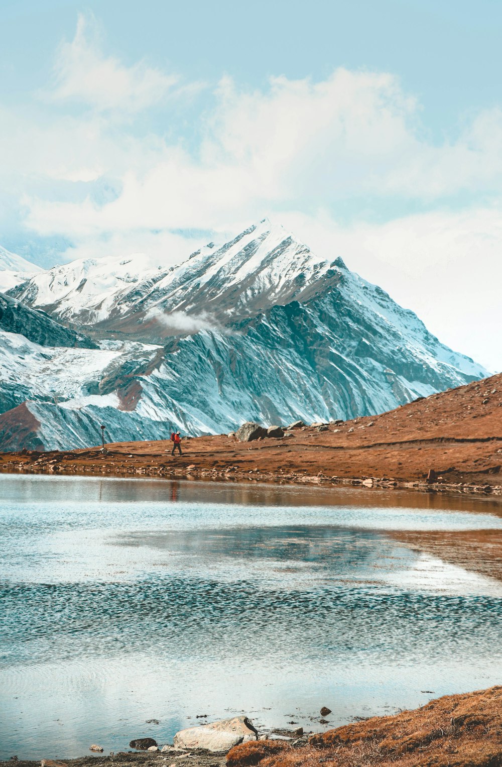 a large body of water with a mountain in the background