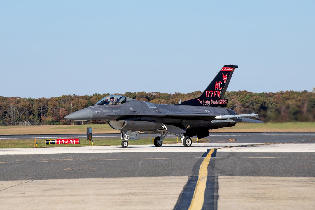 a fighter jet sitting on top of an airport runway, The F-16 for the first time since being decorated with its new tail f
