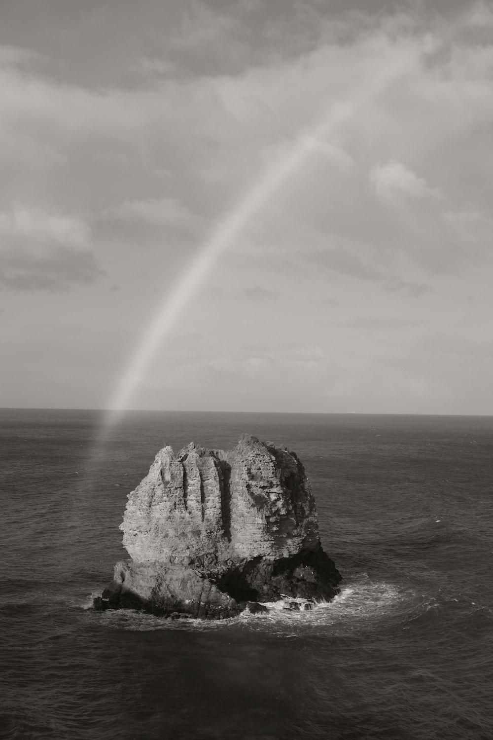 a rainbow in the sky over a large body of water