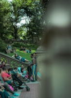 An outdoor scene of people sharing ideas in a casual park setting.