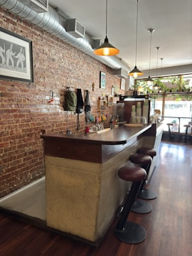 A vibrant café interior captured with warm lighting and rich burgundy accents.