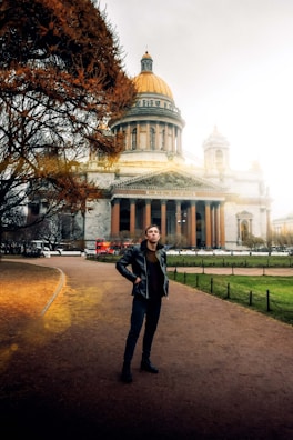 A young professional standing proudly in front of the UK Parliament.