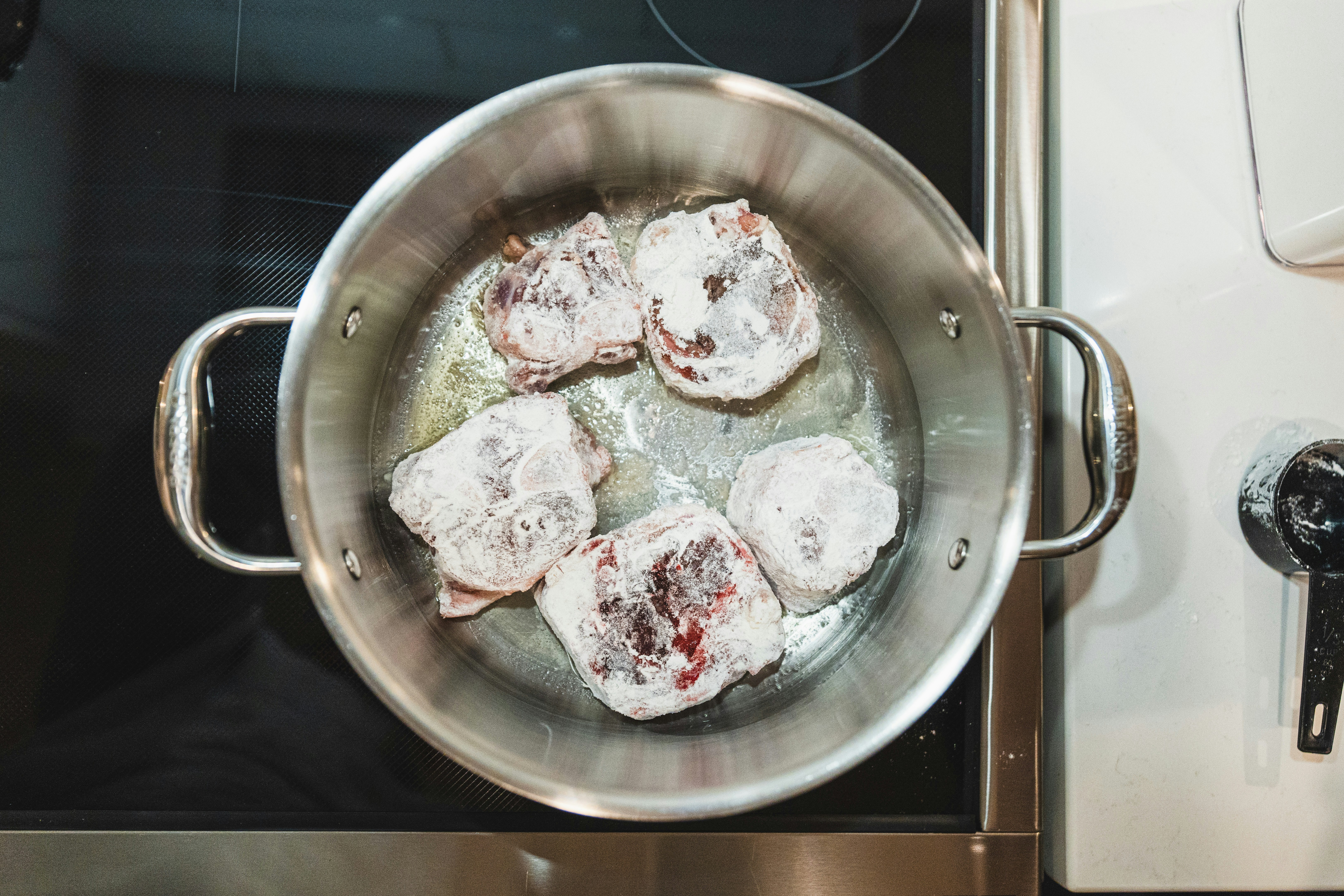 a pan filled with food sitting on top of a stove