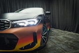 a close up of a car with a rainbow paint job
