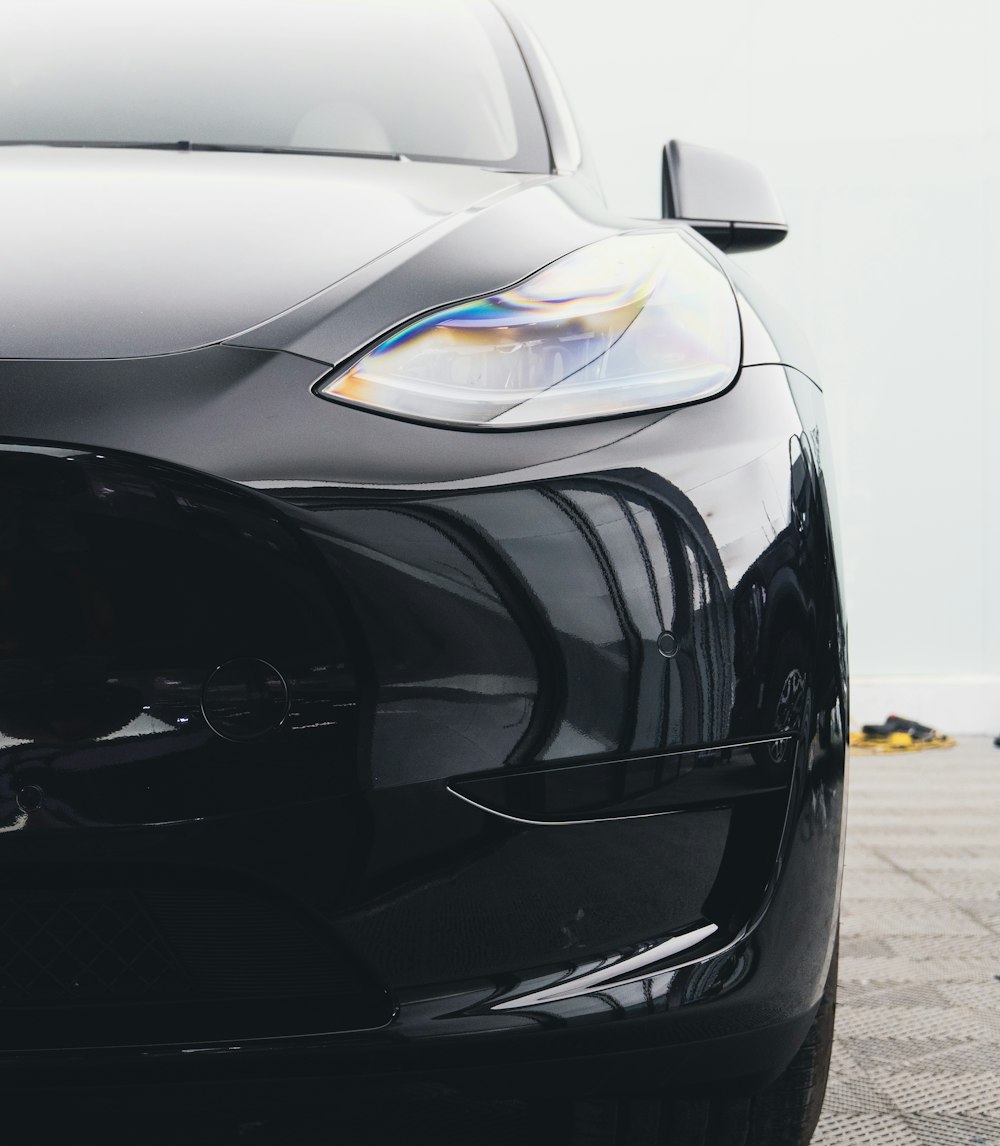 the front end of a black sports car