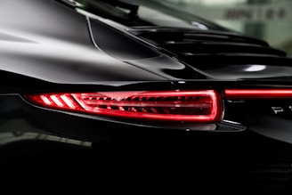 the tail lights of a black sports car