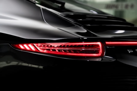 the tail lights of a black sports car
