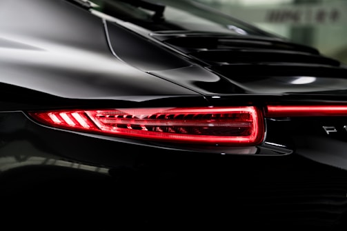 the tail lights of a black sports car