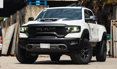 A rugged Ram dually truck in gunmetal grey, branded with the Blackbelt Roadrunner Transport logo, ready for local and regional freight.
