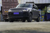 Vehicle wrapped in matte black vinyl with crisp white logo decals.