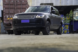 A sleek matte gold logistics truck against a deep charcoal black background, symbolizing precision and luxury.