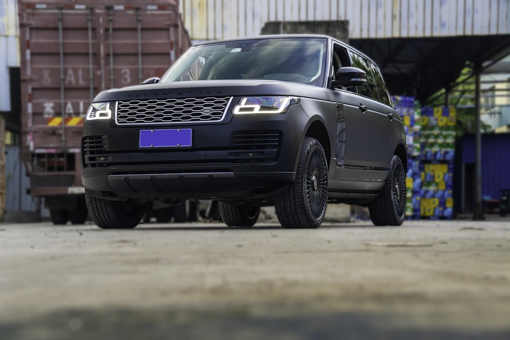 a black suv parked in front of a building