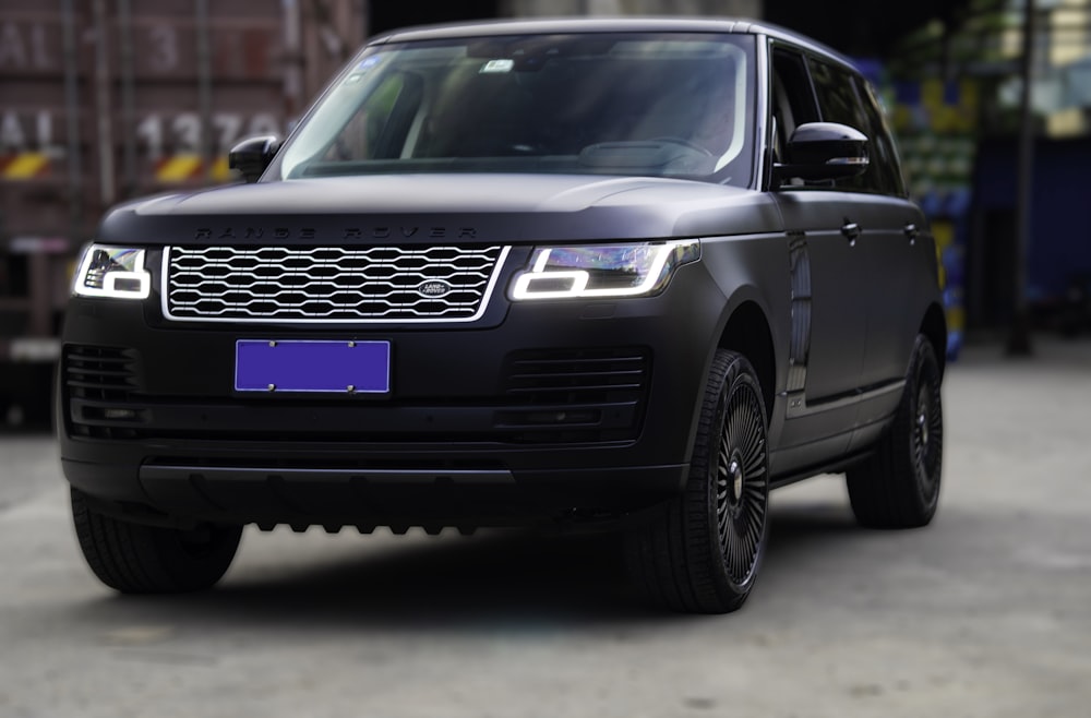 a black range rover parked in front of a building