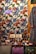 A richly decorated scene featuring a tapestry adorned with colorful floral and butterfly patterns in vibrant shades of orange, blue, and green. In front, an assortment of intricately painted ceramic items, including vases, bowls, and boxes, are displayed. A patterned bag with pink embroidery is prominently positioned at the bottom. Adjacent is a garment with floral motifs, hinting at artisanal craftsmanship.