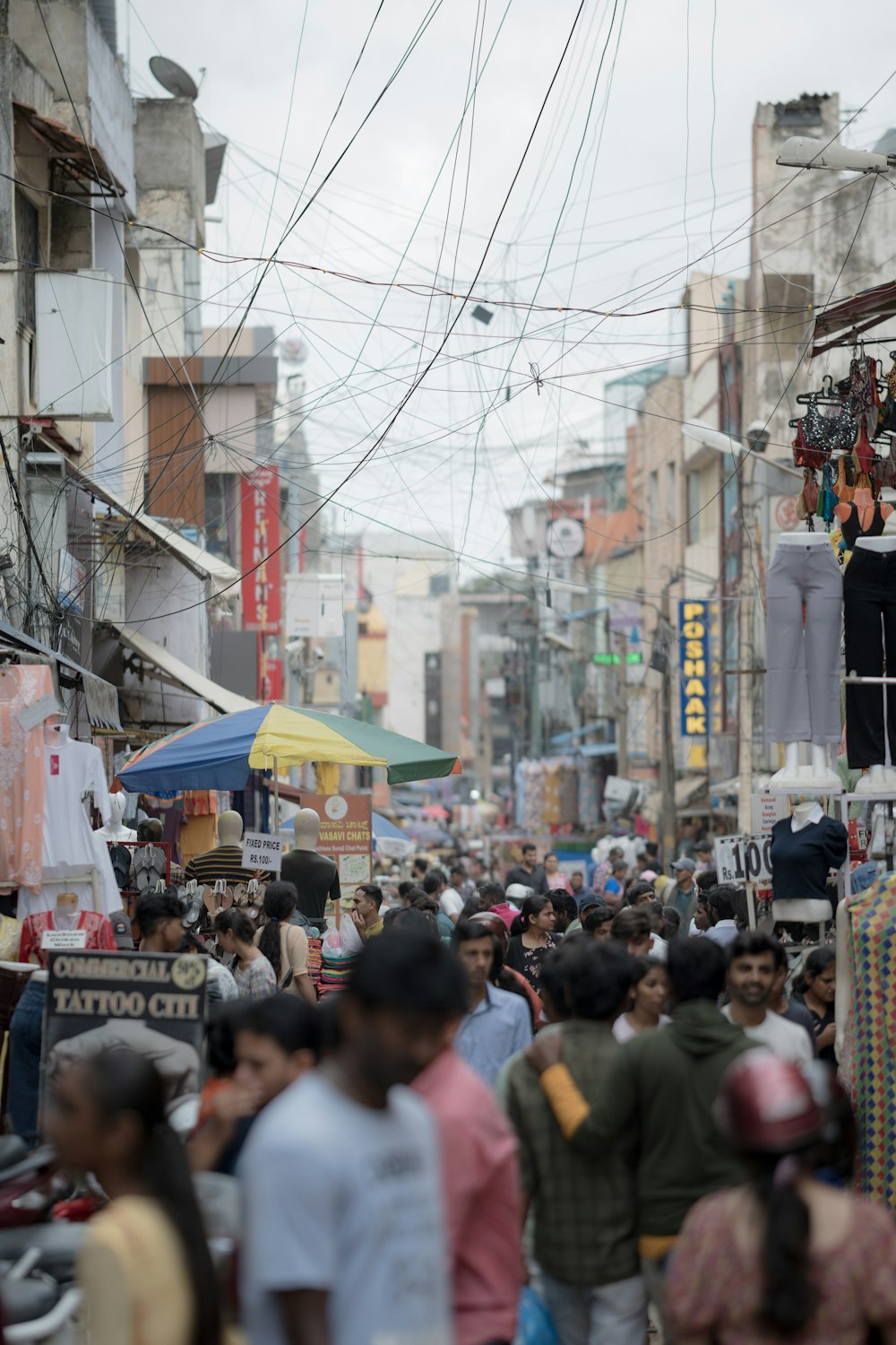 a crowd of people walking down a busy street