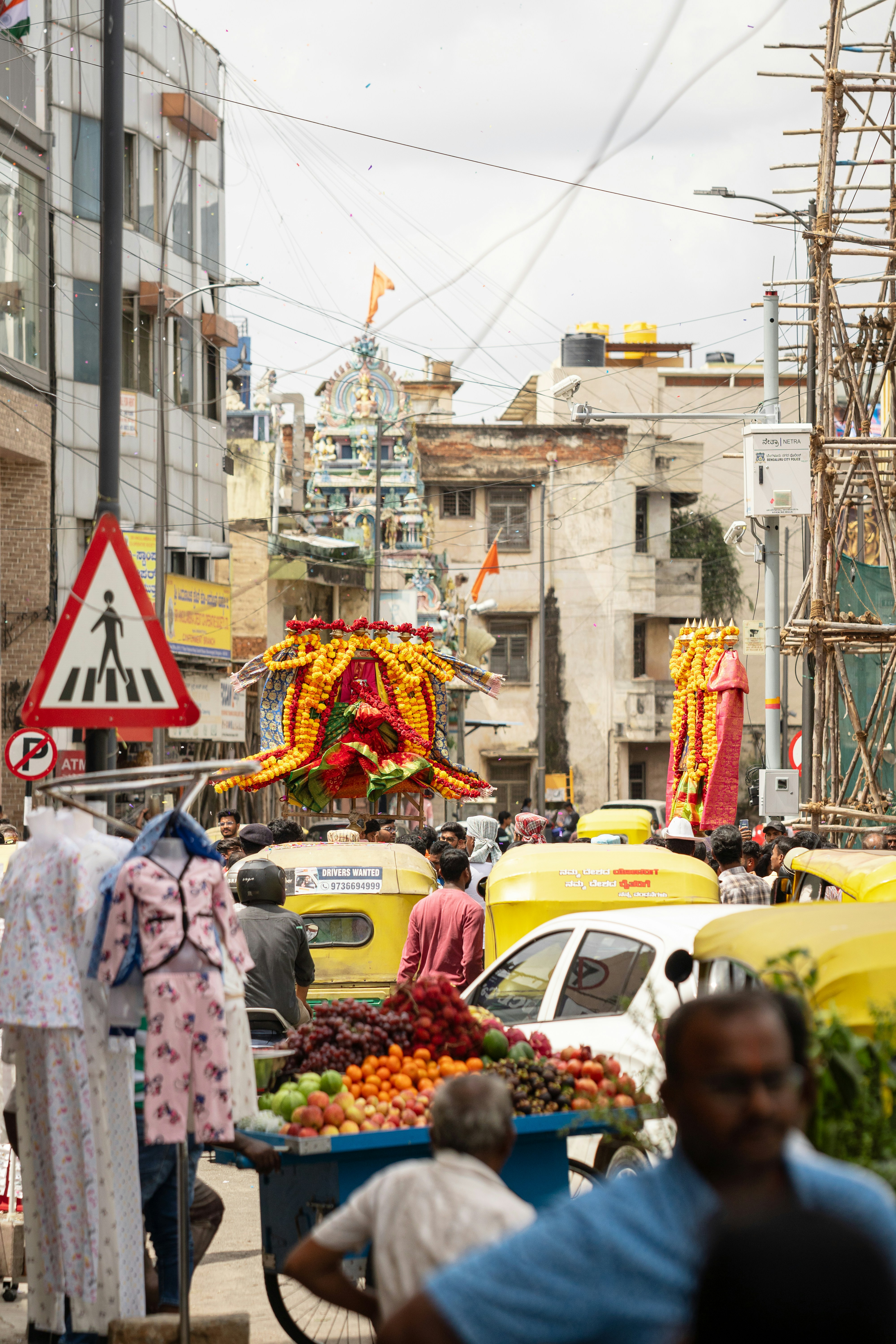 A bustling street scene in Agartala at sunrise, with vibrant colors and early morning activity.