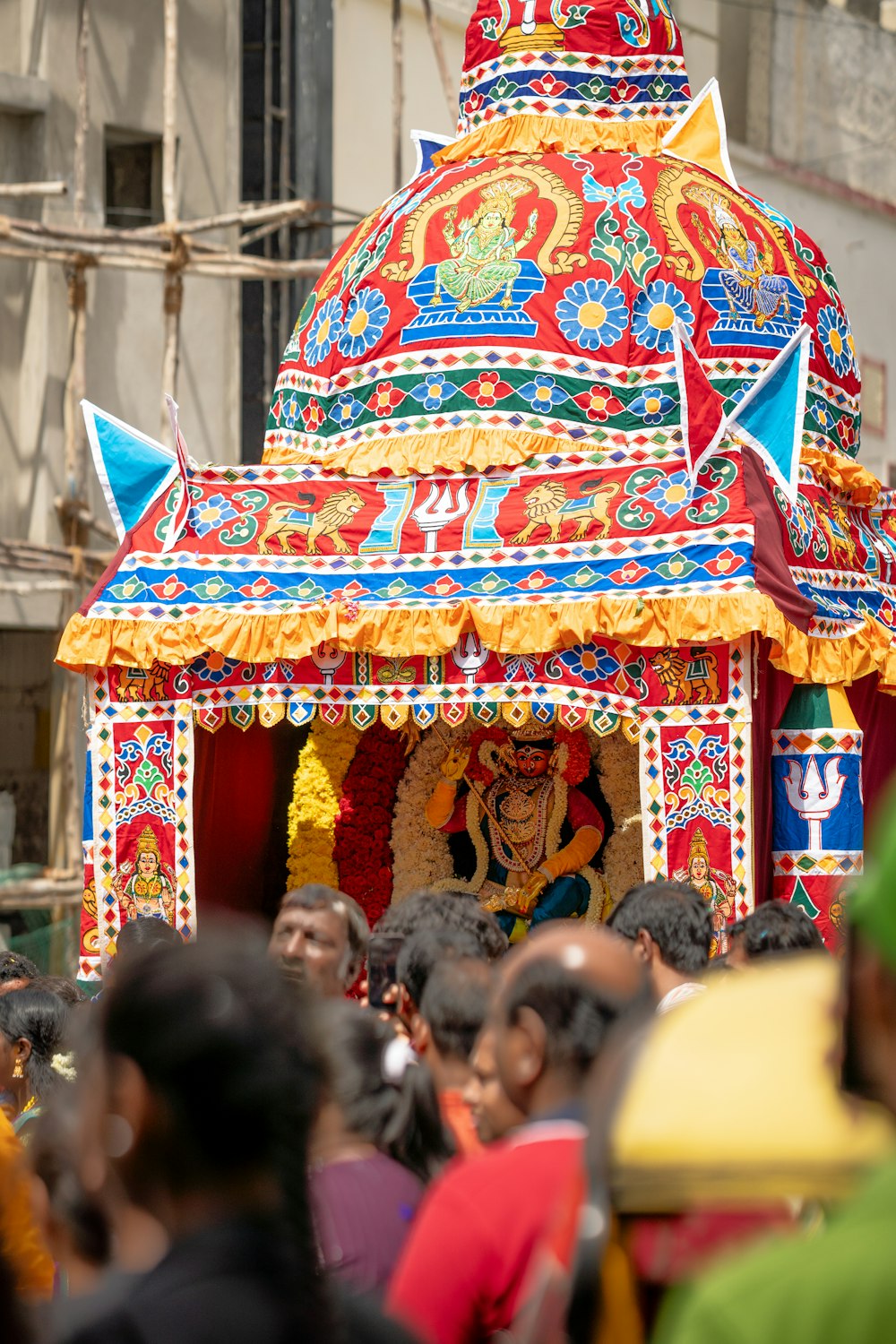 a colorfully decorated shrine in the middle of a crowd