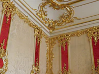 Interior renovation project with red and gold design features being installed
