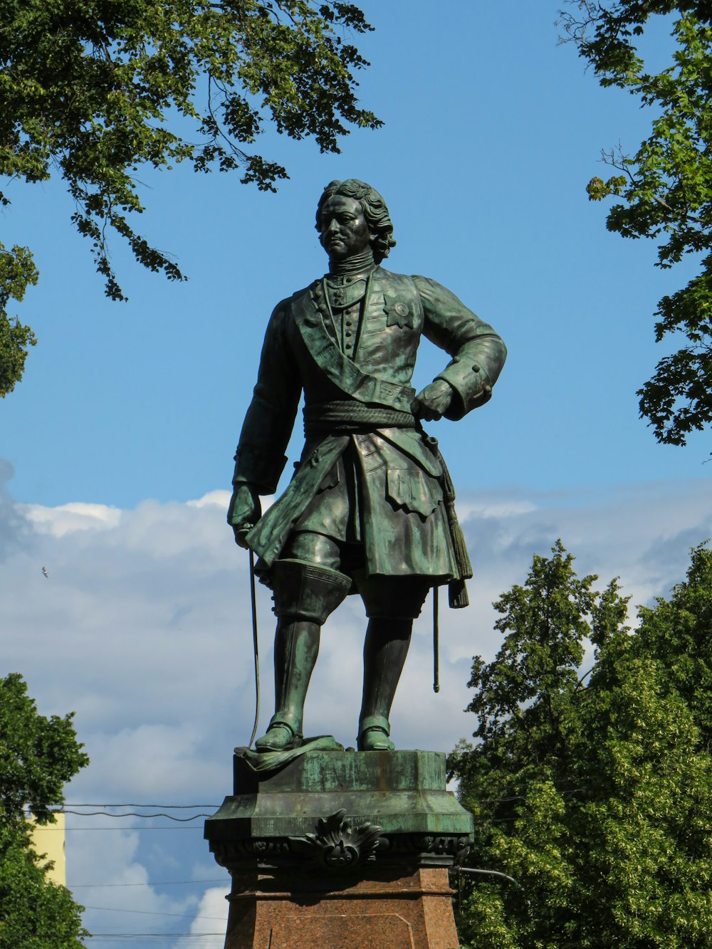 a statue of a man holding a cane