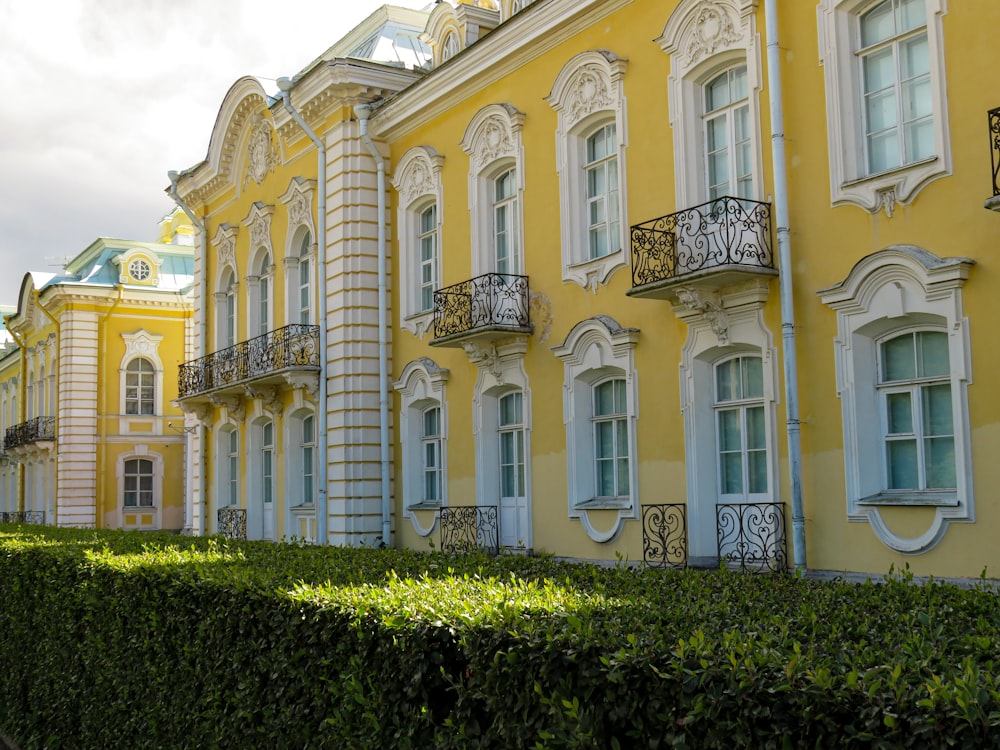 a large yellow building with many windows and balconies