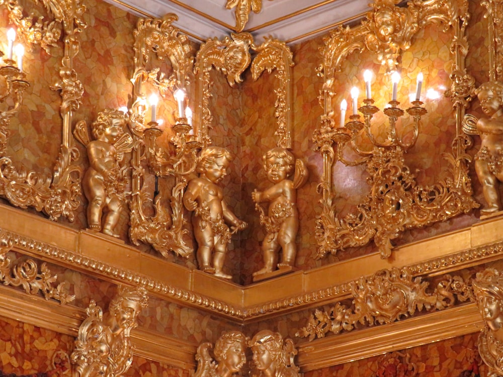 a gold painted room with a chandelier and candles