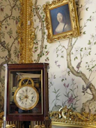 A beautifully decorated room featuring 3D wallpaper and stylish wall clocks.