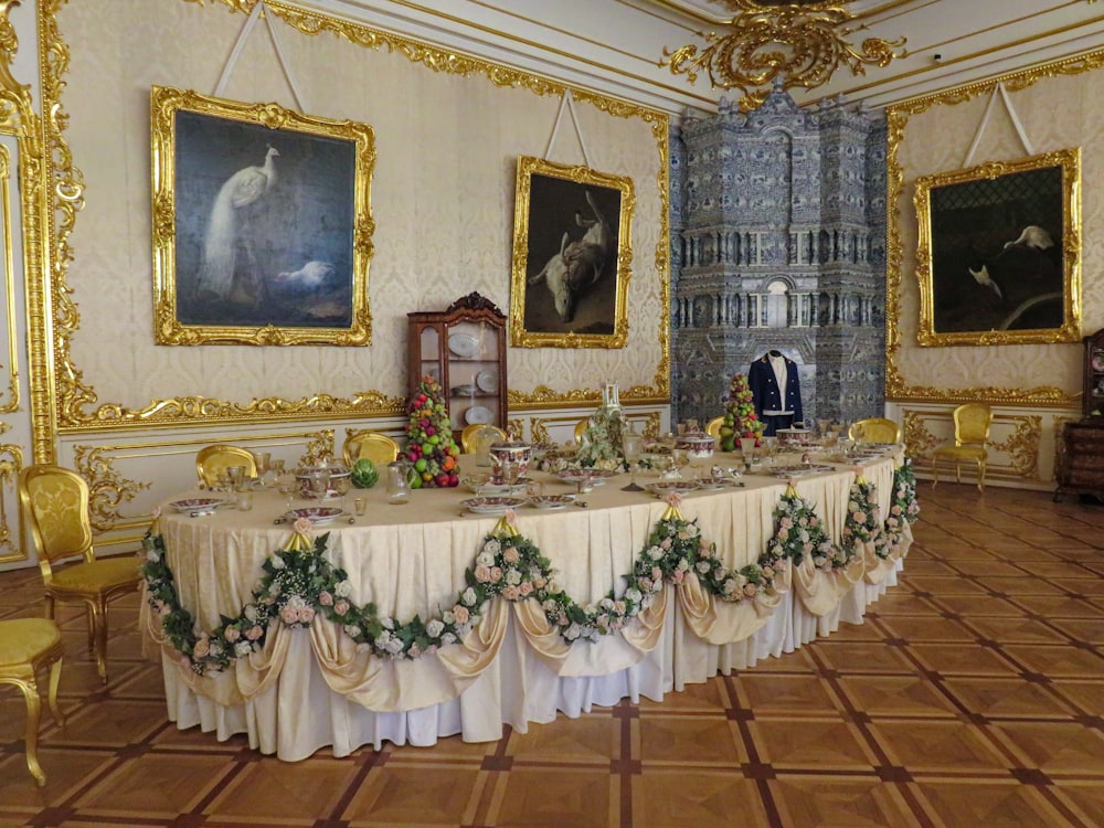 a dining room with a long table covered in flowers