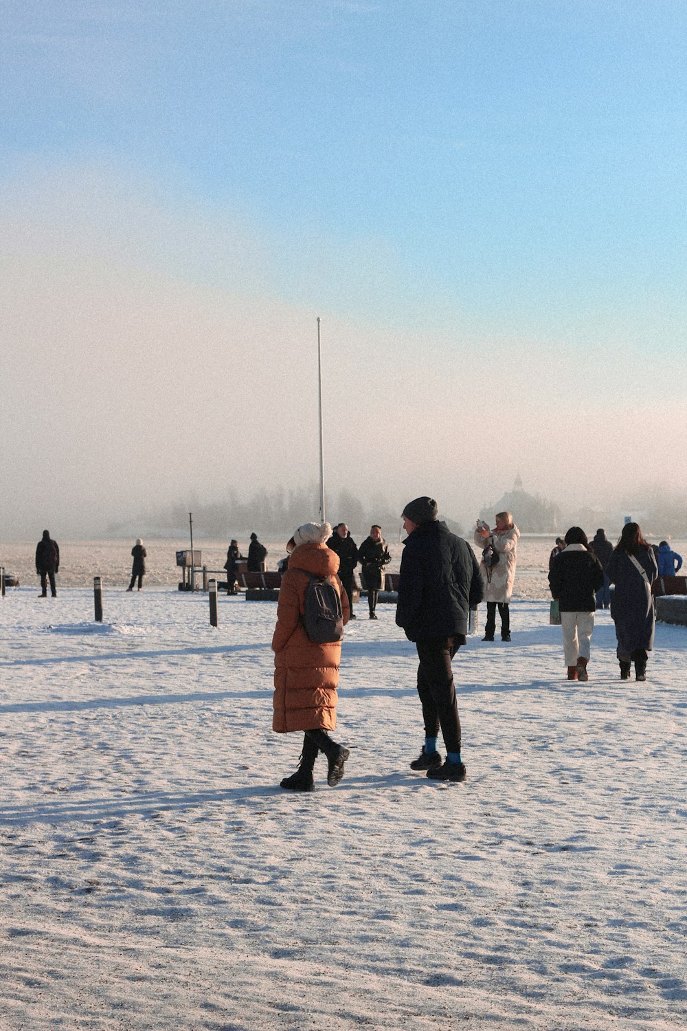 a group of people standing on top of a snow covered field