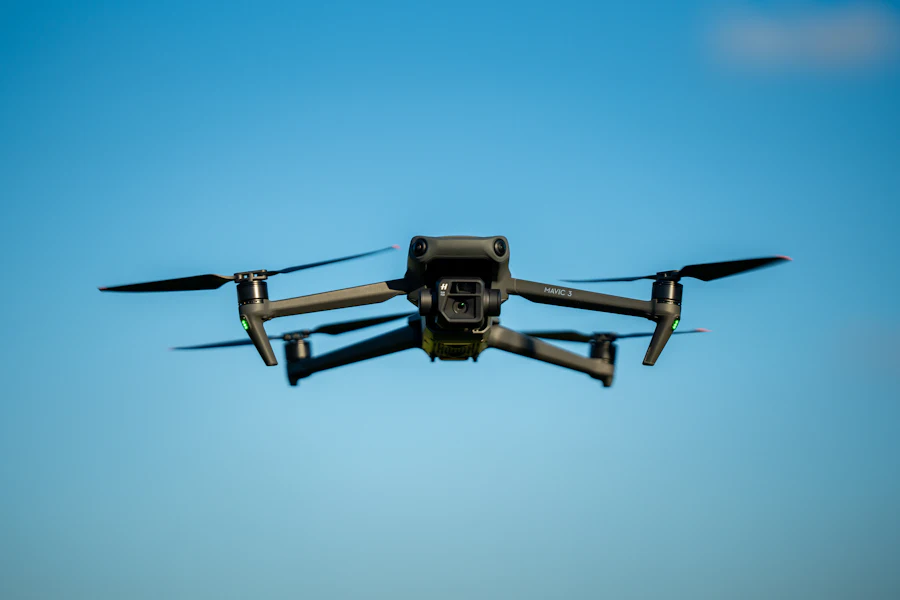 A quadcopter drone in flight against a clear sky