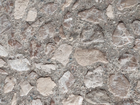 Close-up of a stamped concrete floor with warm earth tones and intricate patterns.