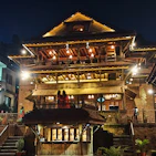 A cozy villa interior featuring warm lighting and traditional Balinese decor.