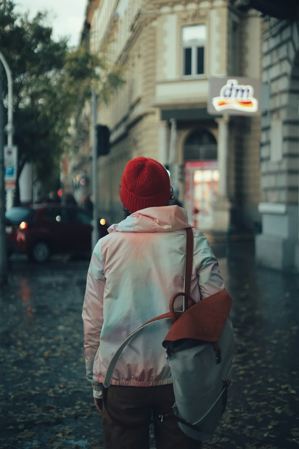 a person walking down a street with a backpack