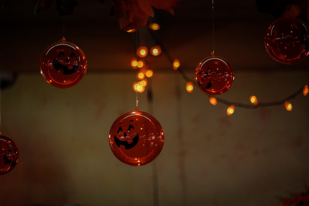 a group of halloween decorations hanging from a ceiling
