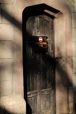 Secure facility entrance in Racoon City at dusk with official signage.